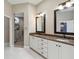 Bright bathroom featuring dual sinks, granite countertops, a tiled shower, and a private toilet area at 802 Kaywood Dr, Orlando, FL 32825