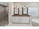 The bathroom features dual sinks, granite countertops, tiled shower, and a luxurious soaking tub at 802 Kaywood Dr, Orlando, FL 32825