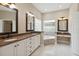 A spacious bathroom with granite countertops, dual sinks, a glass block window, and a soaking tub at 802 Kaywood Dr, Orlando, FL 32825