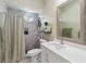 This bathroom features a marble tiled shower with a round window and a vanity at 802 Kaywood Dr, Orlando, FL 32825