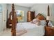 Traditional bedroom features an ornate four poster bed, sitting area, and natural light at 802 Kaywood Dr, Orlando, FL 32825