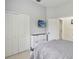This bedroom features white closets, tile floors, and a television screen on the wall at 802 Kaywood Dr, Orlando, FL 32825