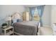 A comfortable bedroom with bright blue accents and a sunlit window view at 802 Kaywood Dr, Orlando, FL 32825
