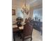 Formal dining room with elegant chandelier, large window, and tastefully decorated table setting at 802 Kaywood Dr, Orlando, FL 32825