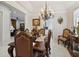 Elegant dining room with a chandelier, traditional furniture, and a view to the living room at 802 Kaywood Dr, Orlando, FL 32825