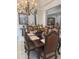 Dining room showcasing a dark wood table with seating for six, ornate chandelier, and neutral colors at 802 Kaywood Dr, Orlando, FL 32825