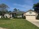 Charming single-Gathering home featuring a two-car garage, manicured lawn, and mature trees at 802 Kaywood Dr, Orlando, FL 32825