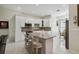 Modern kitchen with an island, white cabinets, stainless steel appliances, and bar seating at 802 Kaywood Dr, Orlando, FL 32825