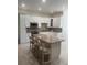 Bright kitchen featuring white cabinets, granite countertops, stainless steel appliances, and a center island with seating at 802 Kaywood Dr, Orlando, FL 32825