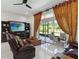 Relaxing living room featuring comfortable seating, a large TV, and access to an outdoor patio at 802 Kaywood Dr, Orlando, FL 32825