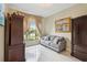 Cozy sitting room with neutral sofa, natural light, and dark wood cabinets creates a peaceful retreat at 802 Kaywood Dr, Orlando, FL 32825