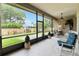 Enjoy relaxing in this screened in patio with comfortable chairs and beautiful yard views at 802 Kaywood Dr, Orlando, FL 32825