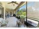 Enjoy relaxing in this screened in patio with comfortable chairs and beautiful yard views at 802 Kaywood Dr, Orlando, FL 32825