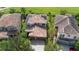 An aerial view of a two-story house featuring a tile roof, a brick driveway, and a two-car garage at 8312 Prestbury Dr, Orlando, FL 32832