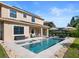 Gorgeous backyard featuring in-ground pool and spa, patio conversation and dining areas, and lush green lawn at 8312 Prestbury Dr, Orlando, FL 32832