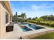 Lush landscaping surrounds a backyard with an in-ground pool, spa, dining area and patio conversation area at 8312 Prestbury Dr, Orlando, FL 32832