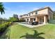 Expansive backyard featuring manicured lawn, in-ground pool and spa, patio dining, and privacy landscaping at 8312 Prestbury Dr, Orlando, FL 32832