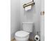 Neutral-toned powder room featuring a standard toilet and a minimalist shelf with towels and plant at 8312 Prestbury Dr, Orlando, FL 32832