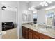 Bathroom featuring double vanity, granite counters, and connection to sitting room at 8312 Prestbury Dr, Orlando, FL 32832