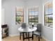 Bright breakfast nook features a glass-top table and neutral decor, with views of the pool at 8312 Prestbury Dr, Orlando, FL 32832
