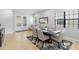 Bright dining room with modern table, rug, chandelier, and view to the front door at 8312 Prestbury Dr, Orlando, FL 32832