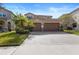 Beautiful two-story home boasts a tile roof, a paver driveway and a spacious three-car garage at 8312 Prestbury Dr, Orlando, FL 32832