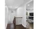Bright hallway with hardwood floors and a view into the living room with a ceiling fan at 8312 Prestbury Dr, Orlando, FL 32832
