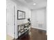 Well-lit hallway featuring dark wood floors, a console table, and doorways to other rooms at 8312 Prestbury Dr, Orlando, FL 32832