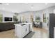 Open concept kitchen boasts stainless appliances, a kitchen island, and a breakfast nook at 8312 Prestbury Dr, Orlando, FL 32832