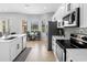 Open concept kitchen boasts stainless appliances, sleek countertops and tile floors at 8312 Prestbury Dr, Orlando, FL 32832