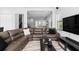 Cozy living room with a large sectional sofa, black coffee table, and views to the staircase at 8312 Prestbury Dr, Orlando, FL 32832