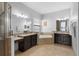 Luxury main bathroom with dual vanities, a soaking tub, and a glass-enclosed shower at 8312 Prestbury Dr, Orlando, FL 32832