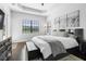 Serene main bedroom with a tray ceiling, dark wood floors, and ample natural light at 8312 Prestbury Dr, Orlando, FL 32832
