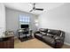 Office with a dark leather sofa, desk, and large window for ample natural light at 8312 Prestbury Dr, Orlando, FL 32832