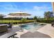 A beautiful pool and spa are surrounded by mature landscaping, patio, and dining, creating the perfect backyard oasis at 8312 Prestbury Dr, Orlando, FL 32832