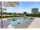 Beautiful in-ground pool featuring an attached spa, patio and umbrella, all surrounded by lush landscaping at 8312 Prestbury Dr, Orlando, FL 32832