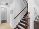 Elegant staircase with dark wood steps, white risers, and decorative iron railings at 8312 Prestbury Dr, Orlando, FL 32832