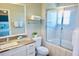 Bright bathroom with a single sink vanity with marble countertops and sliding glass doors on the shower at 944 Park Terrace Cir, Kissimmee, FL 34746
