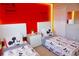 Charming bedroom featuring twin beds with Mickey Mouse themed bedding and a vibrant red accent wall at 944 Park Terrace Cir, Kissimmee, FL 34746