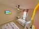 Bedroom with two twin beds, a desk, a ceiling fan and playful cartoon themed decor at 944 Park Terrace Cir, Kissimmee, FL 34746