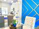 Open dining area with modern table, seating, and stylish blue accent wall with gold trim at 944 Park Terrace Cir, Kissimmee, FL 34746