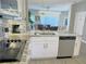 Modern kitchen with stainless steel appliances, granite countertops, white cabinets, and view into living area at 944 Park Terrace Cir, Kissimmee, FL 34746