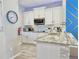 Bright kitchen features stainless appliances, granite countertops, sleek white cabinetry, and decorative backsplash at 944 Park Terrace Cir, Kissimmee, FL 34746