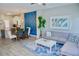 Spacious living area with dining space, comfortable gray sofa, and bright blue accent decor at 944 Park Terrace Cir, Kissimmee, FL 34746