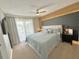 Main bedroom with a modern headboard, decorative lighting, a ceiling fan, and a balcony at 944 Park Terrace Cir, Kissimmee, FL 34746