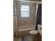 Standard bathroom with tiled walls, bathtub, shower, and toilet, awaiting renovation at 977 E Normandy Blvd, Deltona, FL 32725