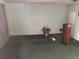 Spacious living room features neutral wall and carpet tones with natural light; in need of refurbishment at 977 E Normandy Blvd, Deltona, FL 32725