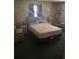 Main bedroom with plush bedding, carpet, natural lighting, and ample space, ready for transformation at 977 E Normandy Blvd, Deltona, FL 32725
