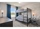 bedroom with a bunk bed, vintage map mural, gray furniture, and natural light at 10172 Hadley St, Orlando, FL 32829