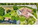 Aerial view of the property with a pool, lush greenery, and waterfront access at 10352 Burris Ct, Orlando, FL 32836